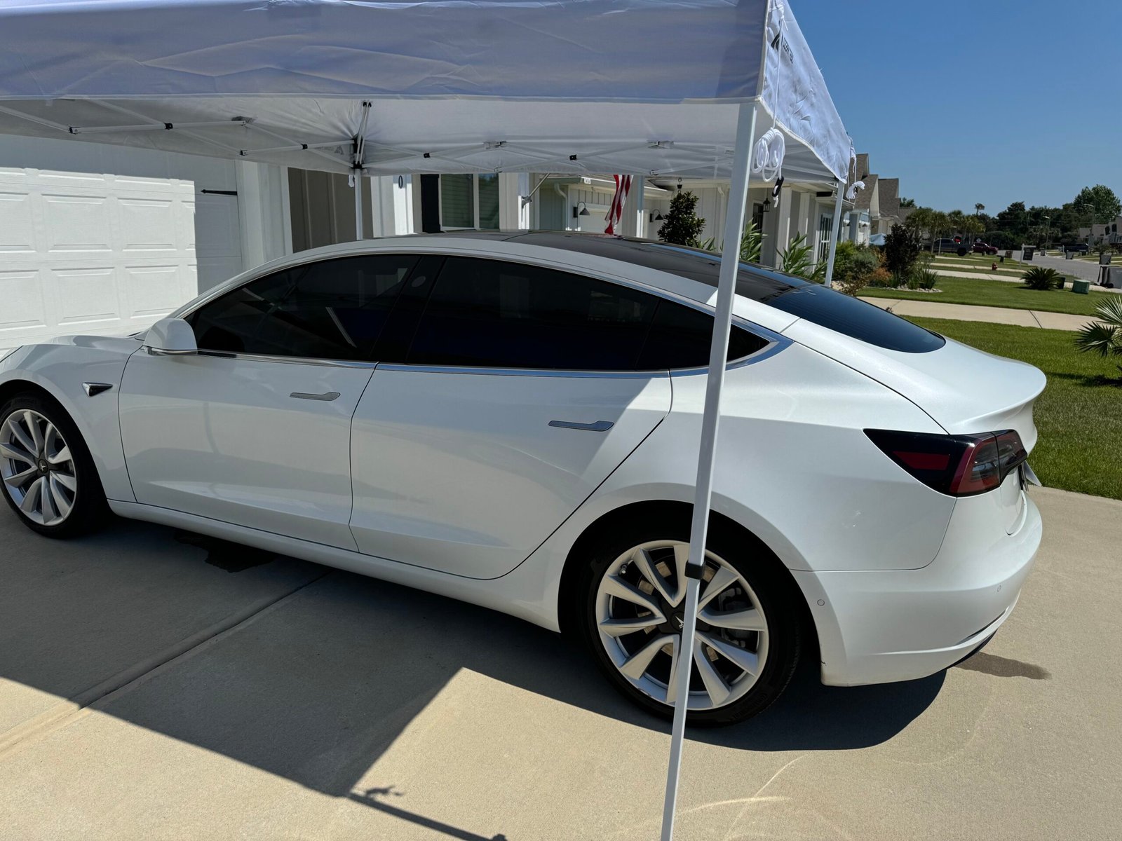 white tesla model 3 being tinted by elite window tinting window tinting near me